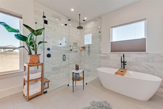 bathroom featuring separate shower and tub and tile walls