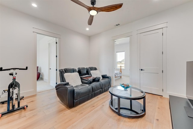 living room with ceiling fan and light hardwood / wood-style floors