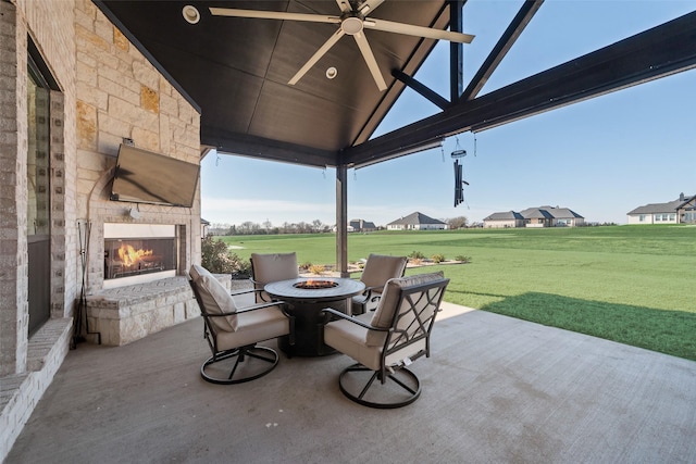 view of patio with a gazebo and an outdoor stone fireplace