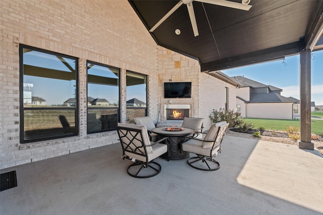 view of patio / terrace featuring ceiling fan and a multi sided fireplace