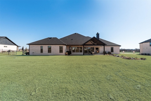 rear view of house with a yard