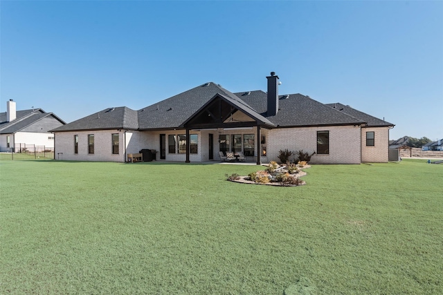 rear view of house with a lawn