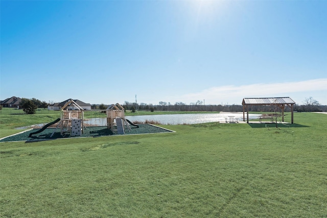 view of jungle gym with a lawn and a water view