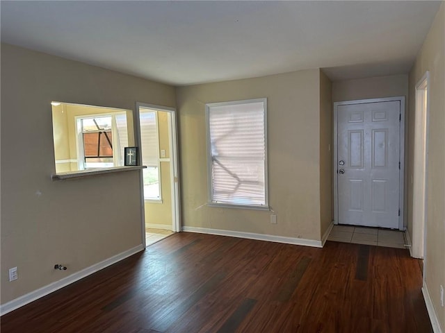 empty room with dark hardwood / wood-style flooring