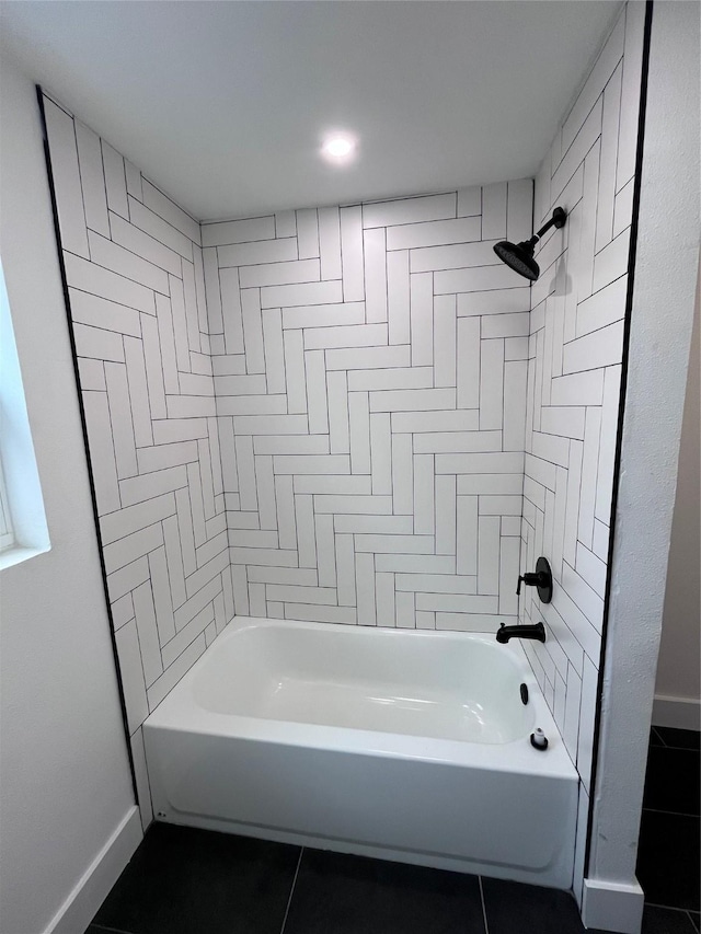 bathroom featuring tiled shower / bath and tile patterned floors