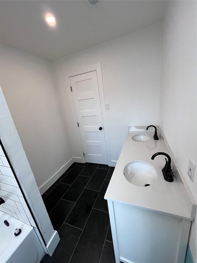 bathroom with tile patterned flooring and vanity