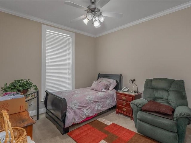 carpeted bedroom featuring crown molding and ceiling fan