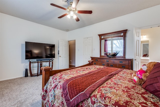 carpeted bedroom with ceiling fan and baseboards