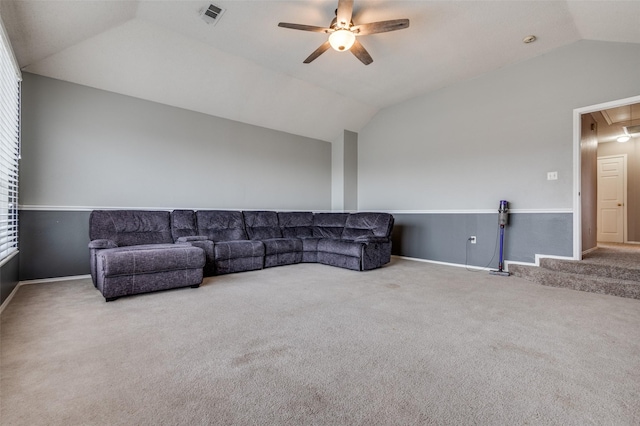 carpeted living room with visible vents, attic access, vaulted ceiling, ceiling fan, and baseboards