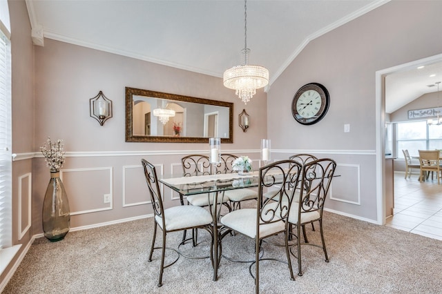 dining room with wainscoting, carpet, vaulted ceiling, a decorative wall, and a notable chandelier