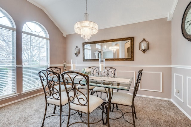 carpeted dining room with a chandelier, lofted ceiling, and crown molding