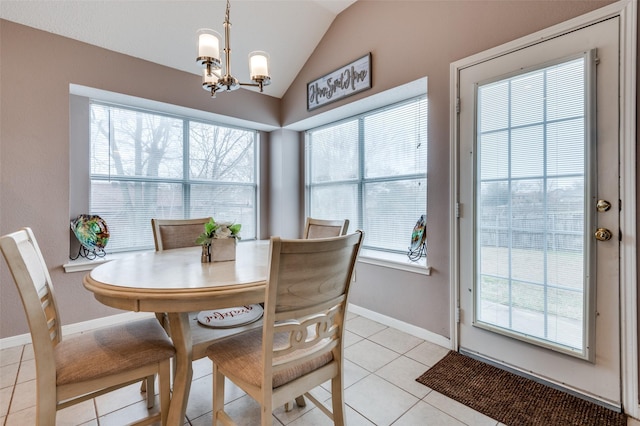 dining space with lofted ceiling, light tile patterned floors, a chandelier, and a healthy amount of sunlight