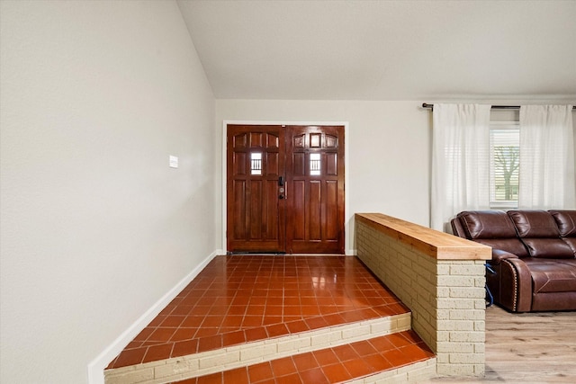 tiled foyer entrance with lofted ceiling