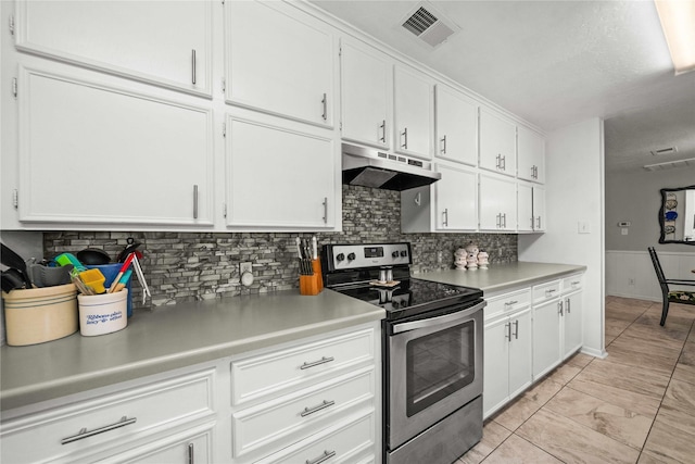 kitchen featuring white cabinetry, stainless steel electric stove, and tasteful backsplash