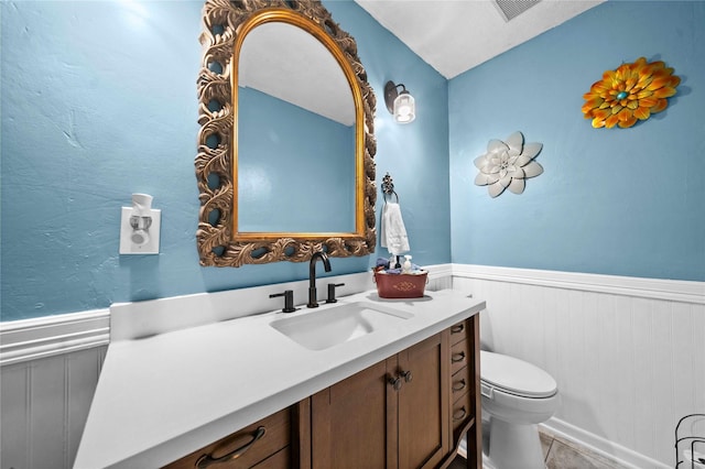 bathroom featuring vanity, toilet, and tile patterned flooring