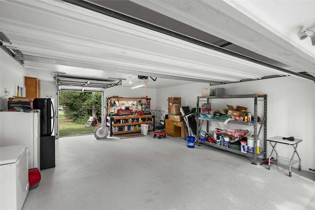 garage with a garage door opener and white refrigerator