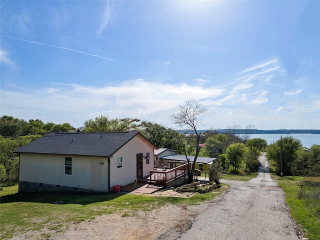 exterior space featuring a deck with water view