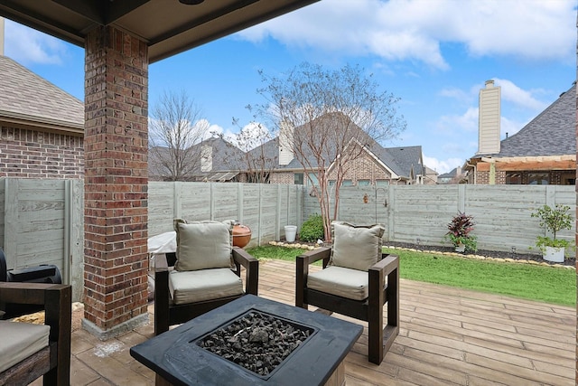 wooden terrace with an outdoor fire pit