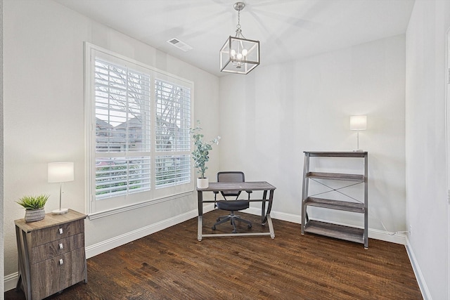 office space with dark hardwood / wood-style flooring and an inviting chandelier