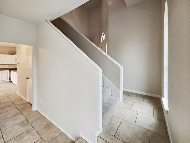 staircase featuring tile patterned floors