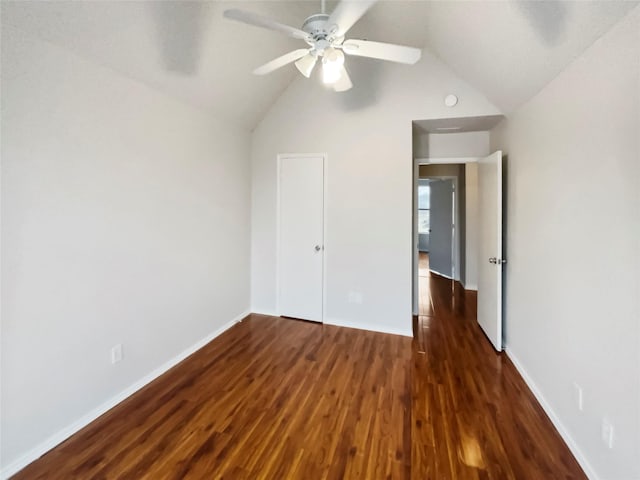 unfurnished bedroom with a closet, vaulted ceiling, dark hardwood / wood-style floors, and ceiling fan