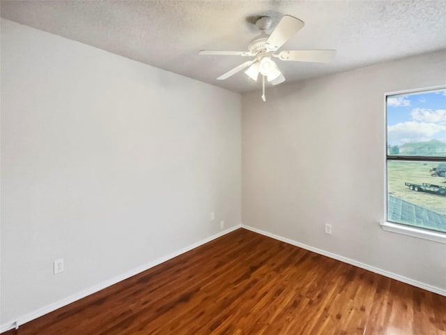 empty room featuring wood-type flooring, ceiling fan, and a textured ceiling