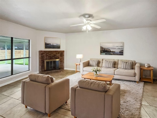 tiled living room with ceiling fan and a brick fireplace