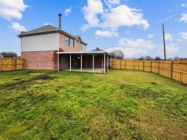 back of house featuring a patio area, a sunroom, and a lawn