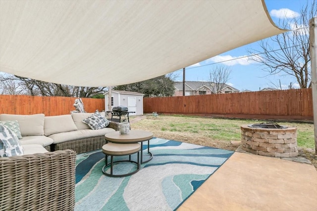 view of patio featuring a shed, an outdoor living space with a fire pit, and area for grilling