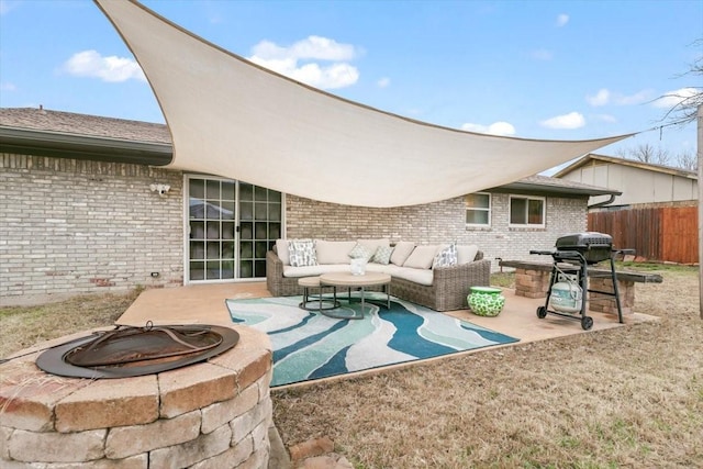 view of patio featuring an outdoor living space with a fire pit