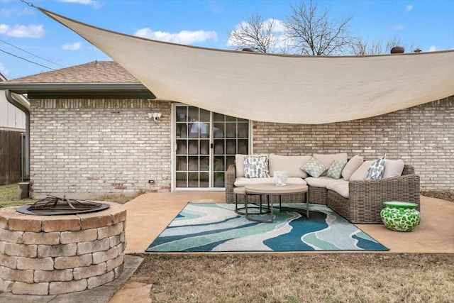 view of patio with an outdoor living space with a fire pit