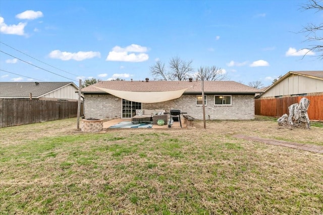 rear view of property with a yard and a patio