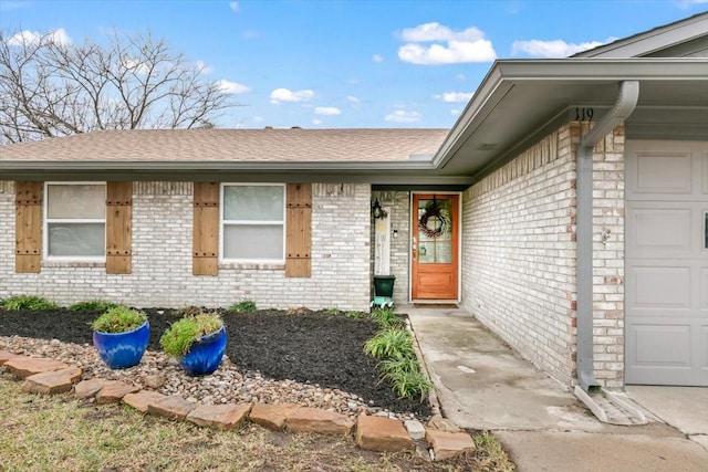 view of exterior entry with a garage