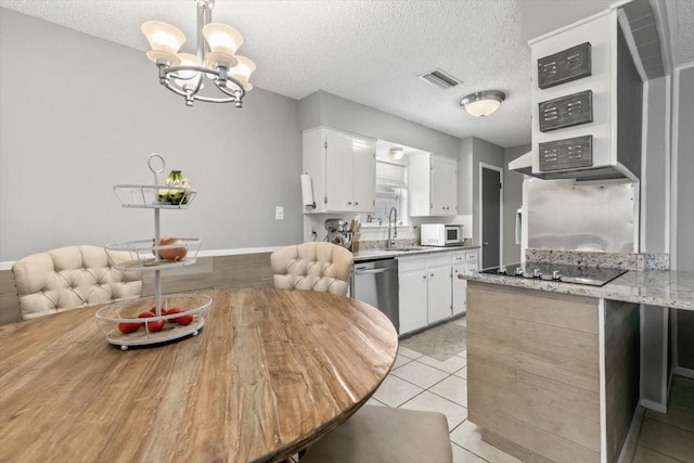 kitchen featuring light tile patterned flooring, dishwasher, white cabinets, light stone countertops, and black electric cooktop