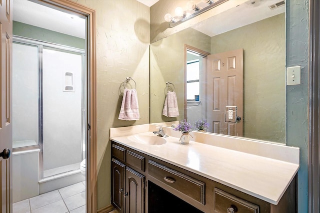 bathroom with vanity, toilet, and tile patterned flooring