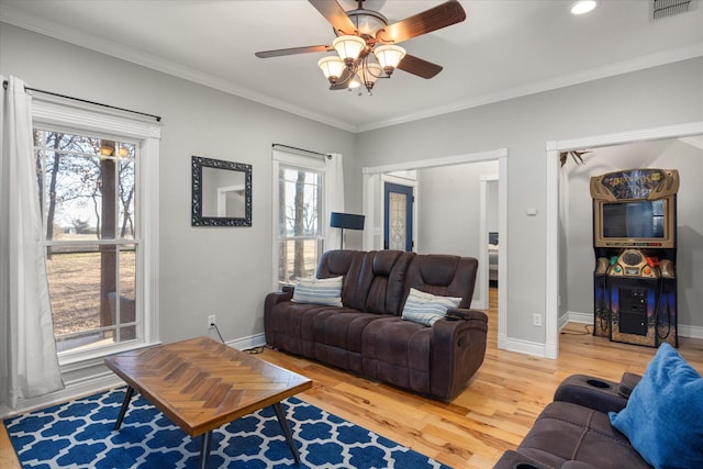 living room with ornamental molding, hardwood / wood-style floors, and ceiling fan