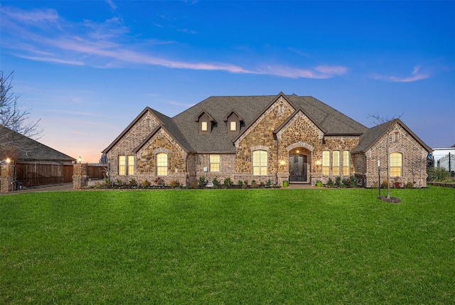 french country style house with a lawn