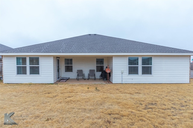 back of house with a patio area and a lawn