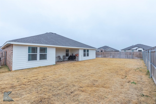 back of house with a lawn