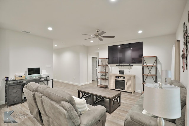 living room featuring ceiling fan and light wood-type flooring