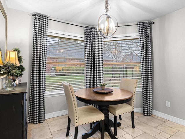 dining area with light tile patterned flooring, plenty of natural light, and a chandelier