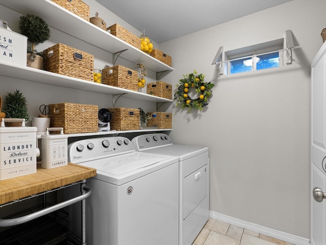 washroom with washer and dryer and light tile patterned floors