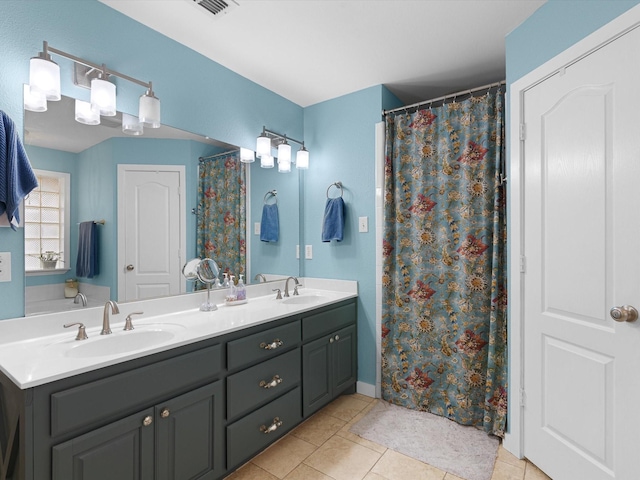 bathroom with tile patterned flooring and vanity