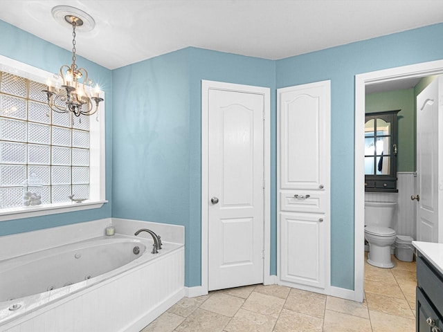 bathroom with vanity, toilet, a bath, and a notable chandelier