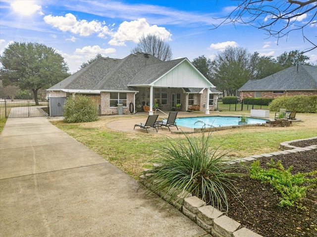 view of swimming pool featuring a patio and a lawn