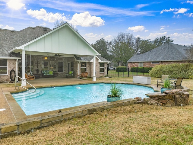 view of pool with a hot tub, a patio, ceiling fan, and a lawn