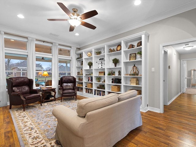 sitting room featuring crown molding, ceiling fan, and dark wood-type flooring