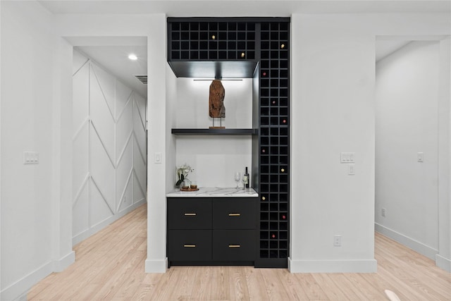 bar featuring light hardwood / wood-style flooring