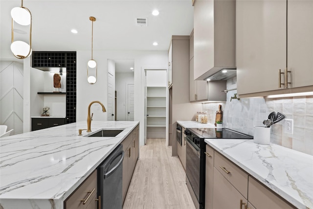 kitchen featuring black electric range oven, sink, hanging light fixtures, dishwasher, and wall chimney range hood