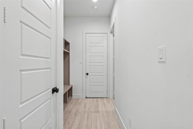 hall with light hardwood / wood-style floors